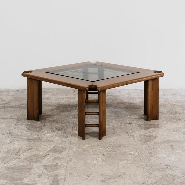 This elegant coffee table from the 1960s, made entirely of wood, perfectly embodies the distinctive design of the period....