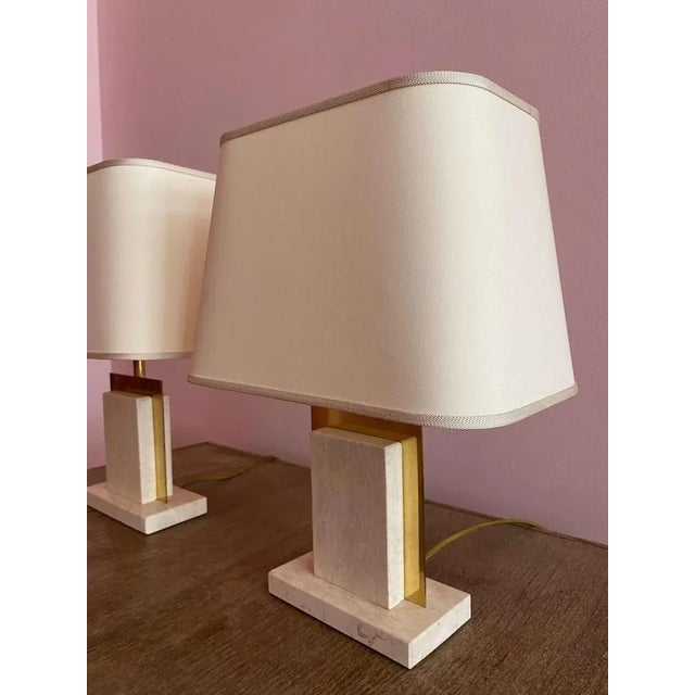 Two antique lamps designed by contemporary designer Camille Breesch. Crafted from travertine blocks, brass detailing and...