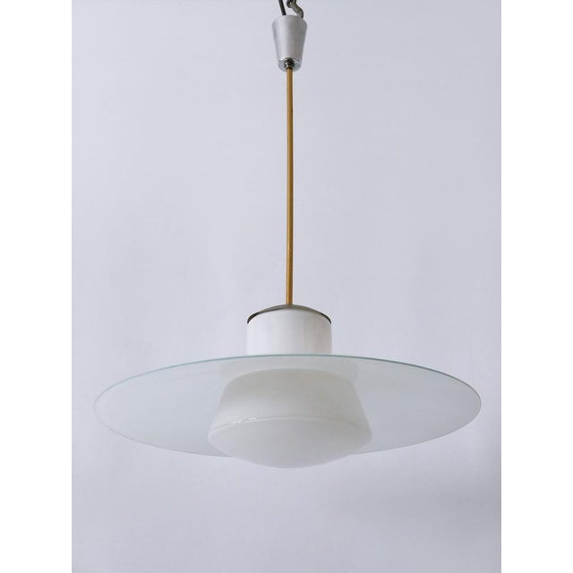 Extremely rare and elegant mid-century modern pendant lamp or hanging light. Catalog no 913/3522 - 55. Designed by...