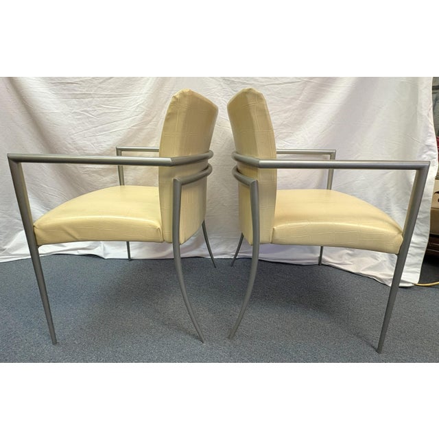 A nice pair of Hickory Business Furniture armchairs from the late 20th century. They have a heavy metal frame in a silver-...