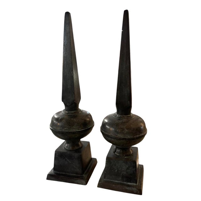 this is an architectural pair of vintage cast iron finials featuring a striking obelisk or spire design. Each piece is...