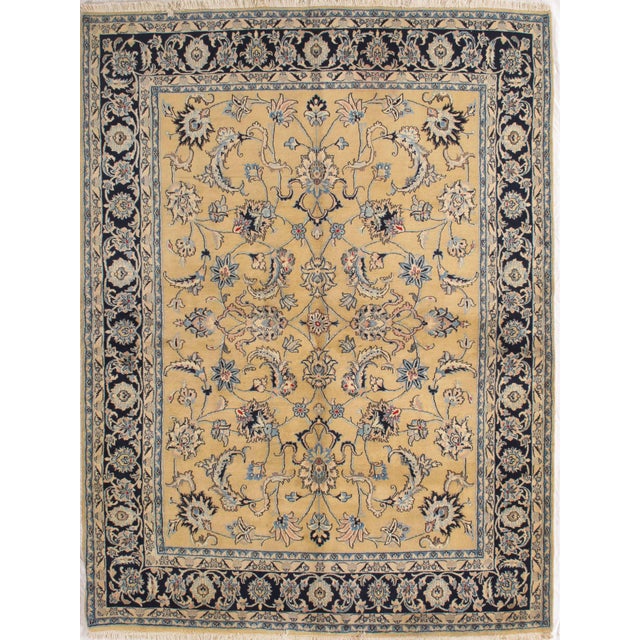 Antique hand-knotted Persian Mashad wool rug with a soft golden-beige field featuring a balanced allover floral pattern of...