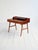 Rosewood desk with slender legs, drawer fronts, and a shelf with compartments and a small drawer. Produced by Vinde...