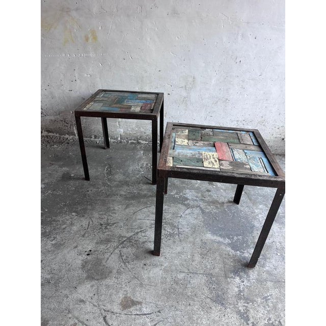 These striking side tables combine industrial iron frames with colourful reclaimed wood tops, creating a unique patchwork...