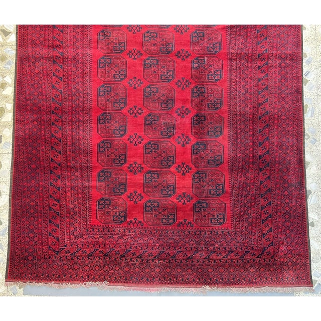 A large vintage Afghan Turkmen Ersari carpet in the Bokhara / "elephant's foot" tradition — three columns of octagonal...