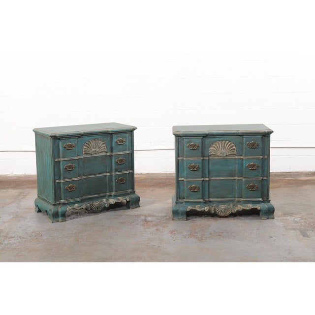 A pair of vintage American painted three-drawer chests with shell motif. These vintage chests have been designed with...