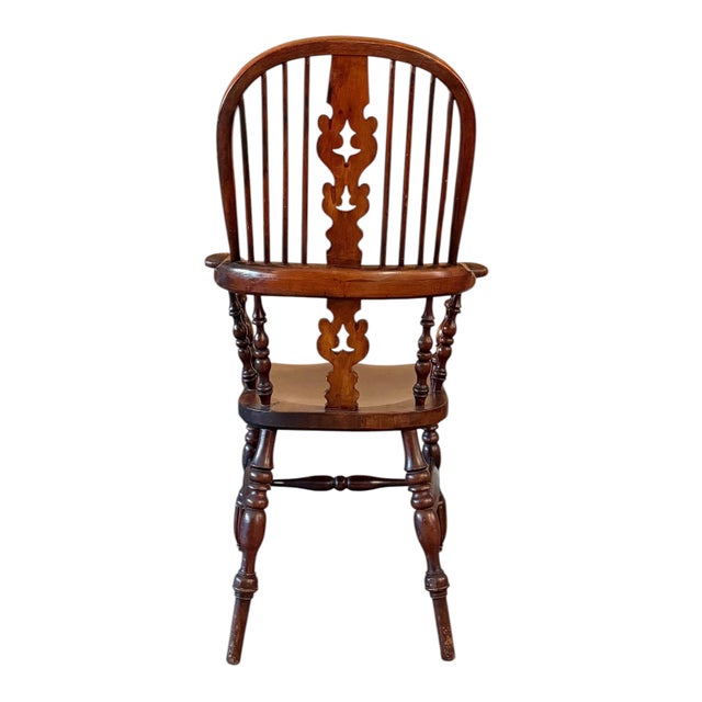 A fine English Windsor chair in elm and ash featuring a classic hoop back with pierced center splat and turned legs...
