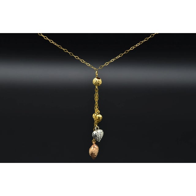 The Zerlina Ladies 14K Tricolor Dangling Heart Necklace. This 18 inch adjustable necklace features three dangling faceted...
