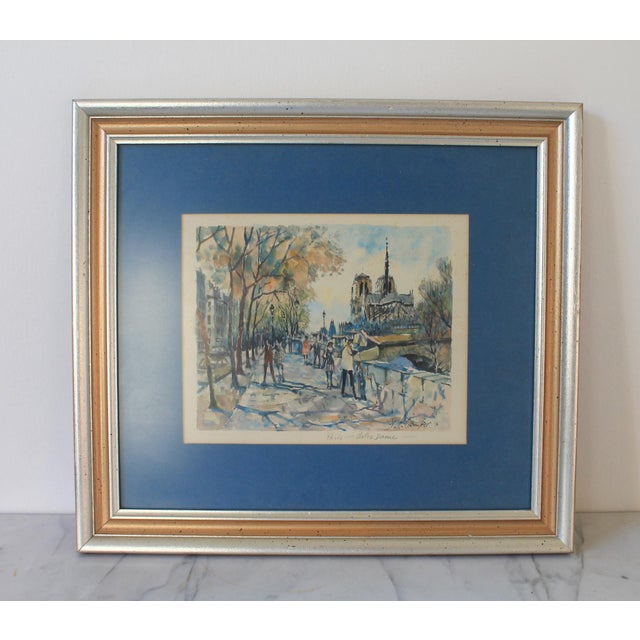 Signed Parisian cityscape lithograph of the Notre Dame Cathedral in Paris. Created by French artist Pierre Eugene Cambier...
