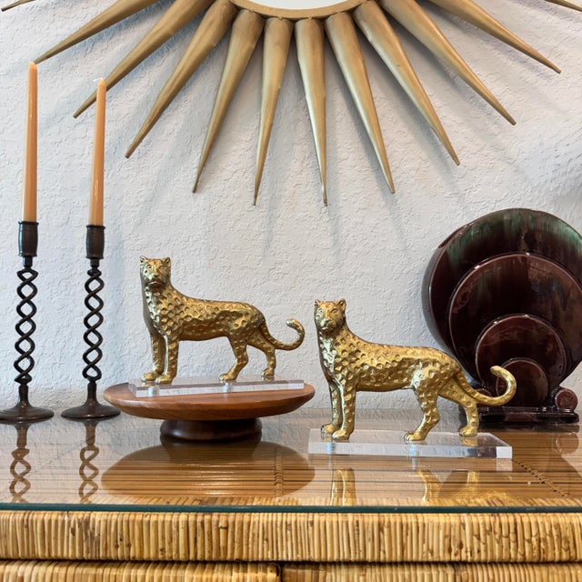 Pair of vintage brass cheetah / leopard sculptures mounted on clear lucite / acrylic bases. Beautifully detailed with...