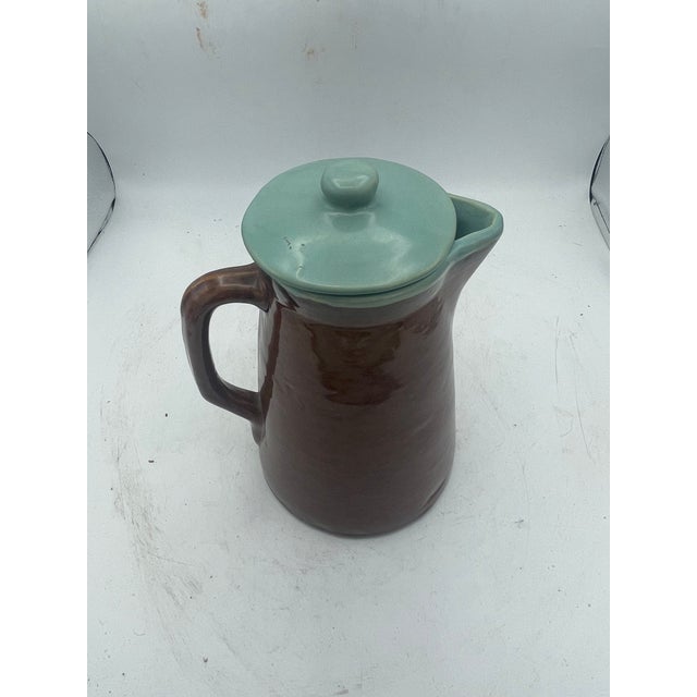 Unique brown and aqua pitcher. The stoneware pottery is in good condition and has lovely color combination. Good condition...