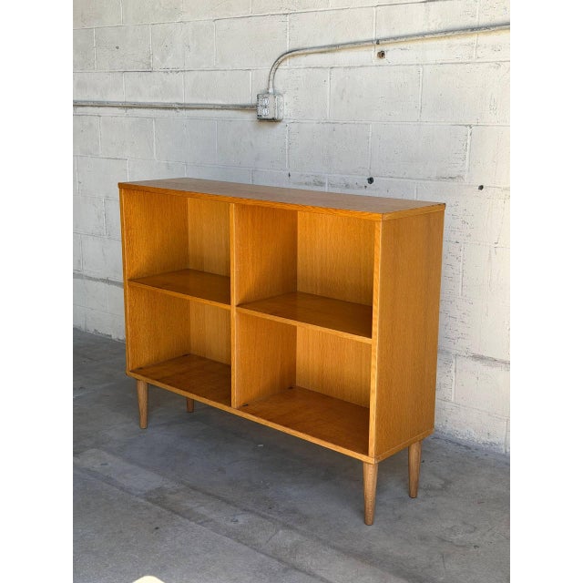 Beautiful vintage Danish bookcase crafted in warm oak with clean Scandinavian Modern lines and elegant tapered legs. This...
