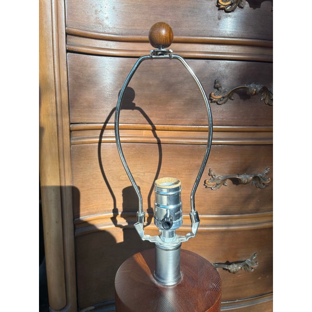 Crafted from warm, richly grained teak, its sculptural form adds a touch of sophistication and natural beauty to any room....