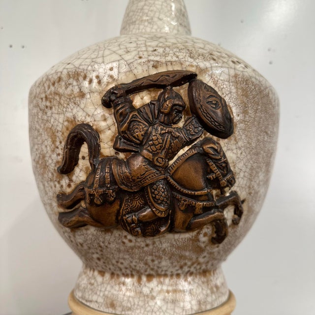 Mid Century Modern Large Scale Ceramic Chinoiserie knight Table Lamp. This table lamp features a knight high relief in a...