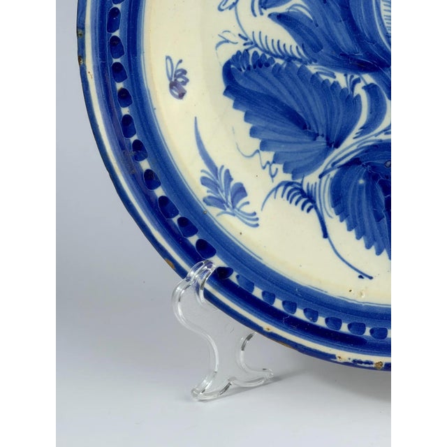 Large antique Spanish majolica plate produced in Manises, Valencia, during the 19th century. Hand-painted in cobalt blue...