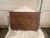 Wall mounted wooden shelf with scalloped edges and. dark finish. The piece includes two brass hooks in a vintage style...