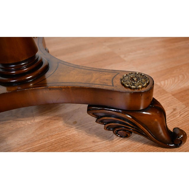 An elegant pair of English Regency-style accent tables dating to the 1930s, crafted with beautifully figured burl maple...