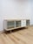 This striking modern MCM sideboard and buffet is a beautifully composed and versatile dining room or living room storage...