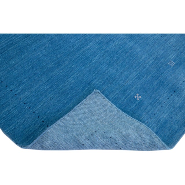 Beautiful modern Gabbeh Style hand-Loom wool rug with a blue field with gorgeous minimalist design. This rug measures:...