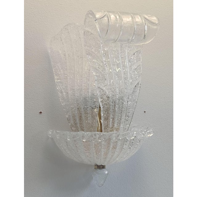Italian wall light with clear Murano glass leaves hand blown in Graniglia technique to produce granular textured effect,...