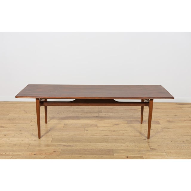 Coffee table made in Denmark in the 1960s. Table top with an interesting grain made of rosewood. The lower part of the...