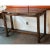 Design Plus Gallery presents a Console Table with Rustic Appeal. The table offers a dark wood finish with a clear lacquer,...