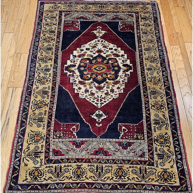 Beautiful Vintage Turkish Oushak rug, meticulously hand-knotted in Anatolia during the second quarter of the 1900s. This...