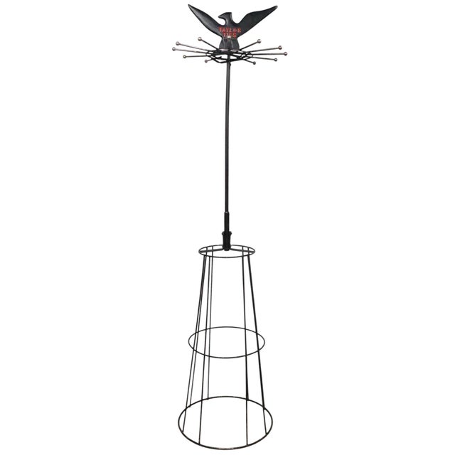 Vintage "Taylor Ties" rotating display, having 12 arms from which to hang ties, mounted on a vertical pole, supported by a...