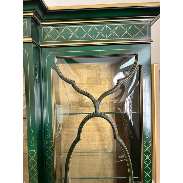 A mid-century custom-made chinoiserie style lighted display breakfront secretary by Karges Furniture with bubble glass...
