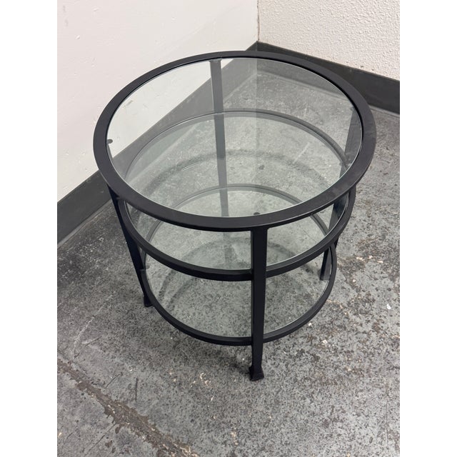 Design Plus Gallery presents the Tanner Round Glass End Table from Pottery Barn. The circular iron frame supports three...
