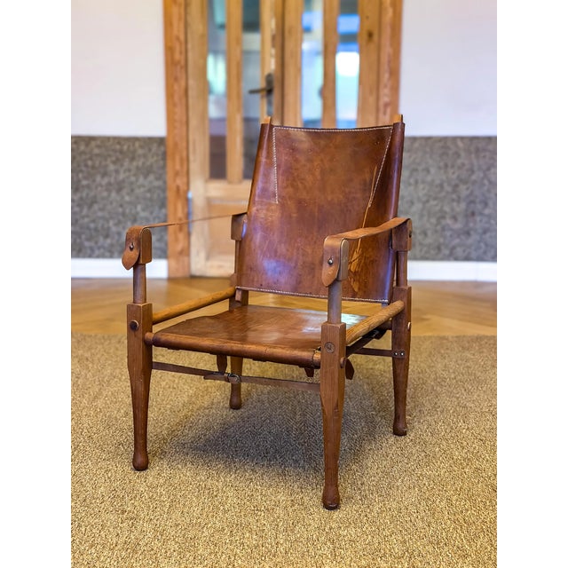 One wonderful natural dark oak wood safari chair, designed by Wilhelm Kienzle / Kare Klint, in 1928 for Wohnbedarf and...