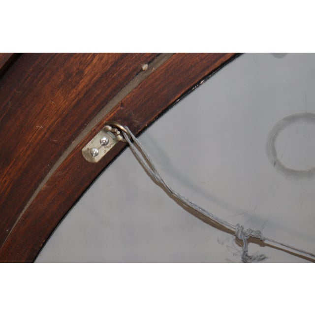 This elegant paint-decorated and gilt oval mirror is distinguished by its deeply modeled frame of overlapping leaves,...