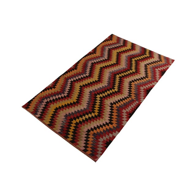 A 5x8 vintage Kilim rug of Afyon design lineage, handwoven in wool from Turkey circa 1950-1960. Enjoying a zig-zag Chevron...