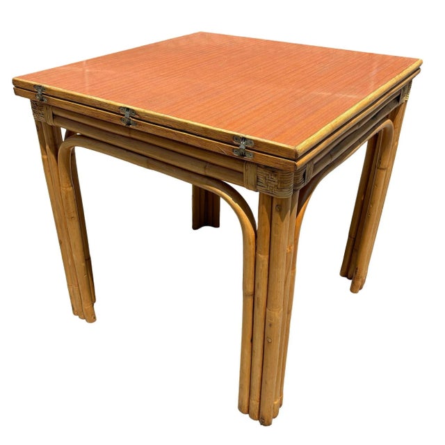 Stylish and laidback restored Mid-century rattan and wood grain Formica dining table. The table includes an expanding...