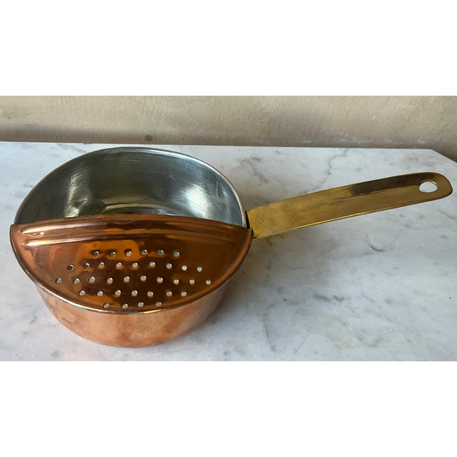 Vintage Copper pot that has been re-tinned making it ready to use. It has a unique permanently attached strainer and brass...