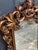 Stunning large 1950s-60s carved wood gilt ornate wall mirror. Excellent condition. Measures 42.5" x 31" including frame.
