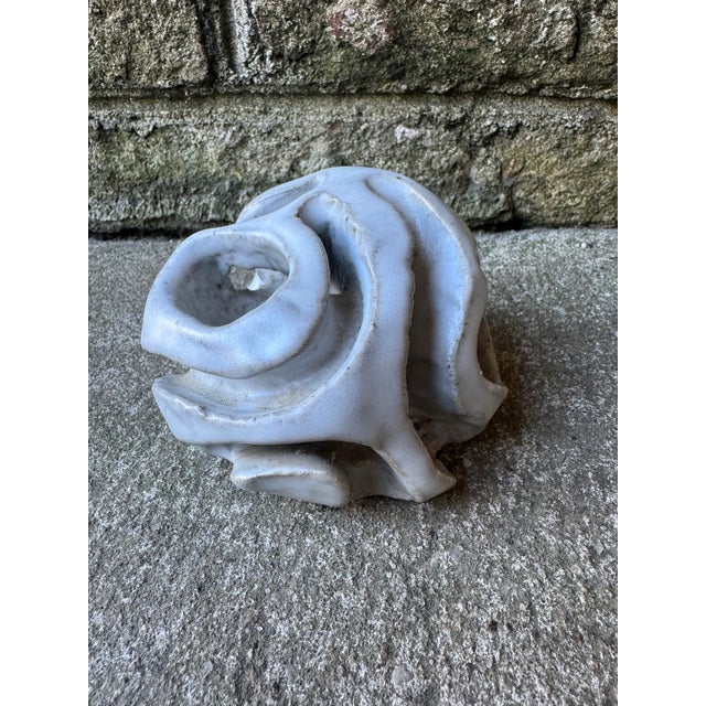 Small white textured ceramic decorative accessory. This piece of table top decor features a hollow inside and textured...
