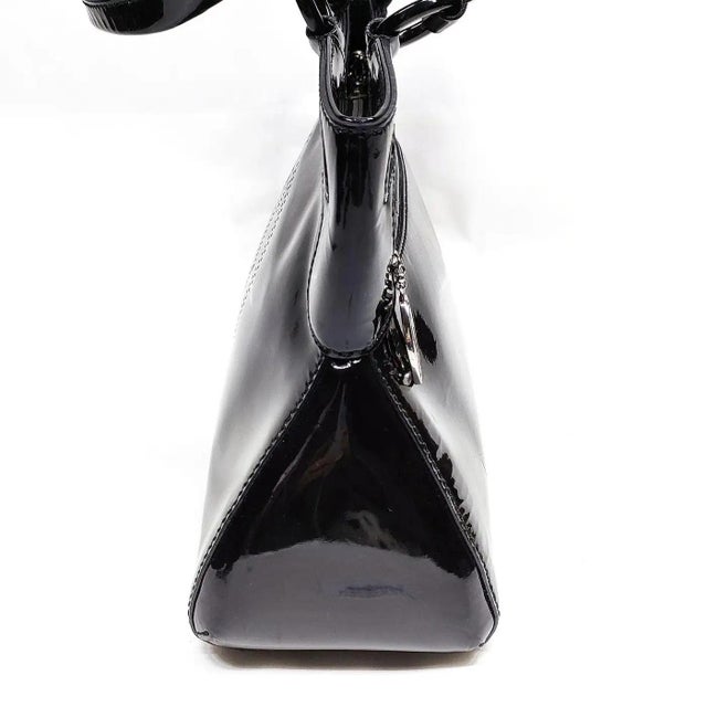This authentic Cartier handbag is a striking example of sophisticated luxury, expertly crafted from high-shine black...