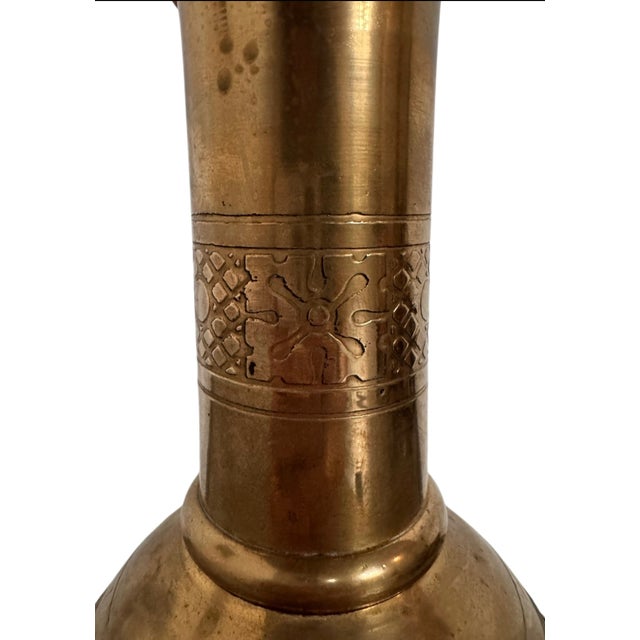 12” Diam x 43”H Evoking the soaring verticality of a medieval cathedral, this imposing brass floor candlestick is a...