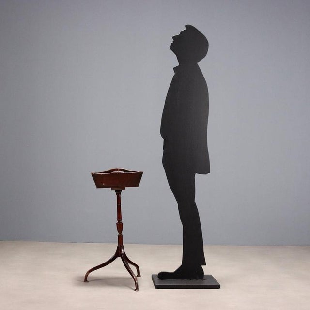 Mahogany valet stand. Pair of open compartments supported by a turned leg resting on three wavy feet. Small defect. Italy,...