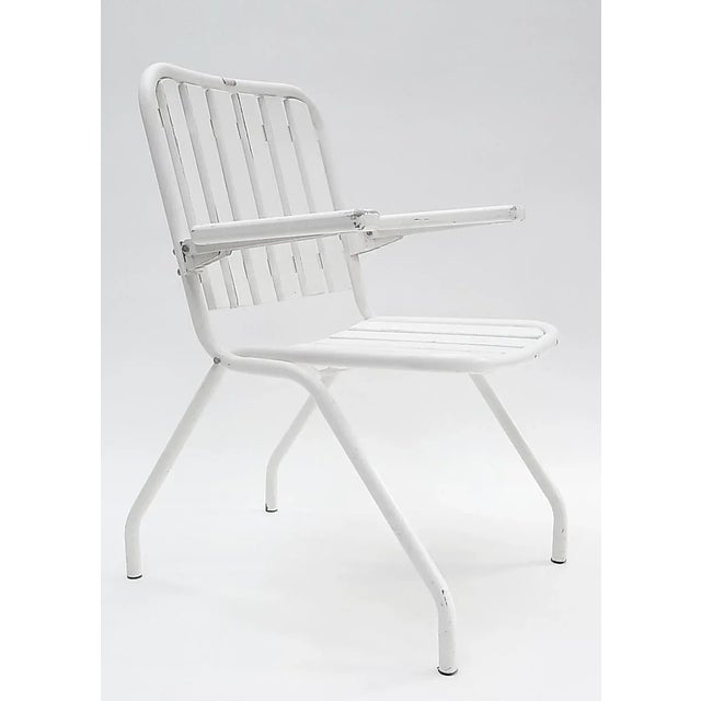 This set of two foldable gardens armchairs features solid structures with solid wood slats. This piece has an attribution...