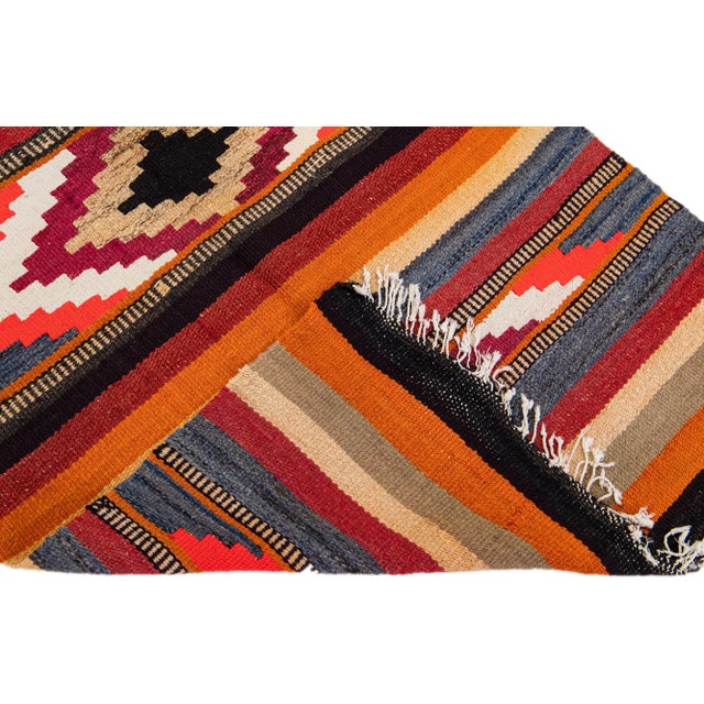 Beautiful vintage Turkish Kilim hand-knotted wool rug with a black field. This piece has multicolor accents in an all-over...
