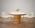 A beautifully crafted round dining table constructed from stacked pencil reed rattan in the California coastal organic...
