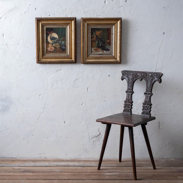 Companion English School oils depicting ripe plums spilling from overturned white bowl with red flower against draped...