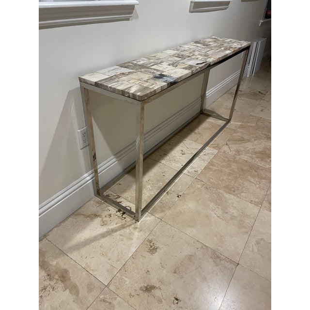 Stone top chrome console table perfect for entrances and living rooms from Jalen Jalen Miami.
