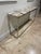Stone top chrome console table perfect for entrances and living rooms from Jalen Jalen Miami.