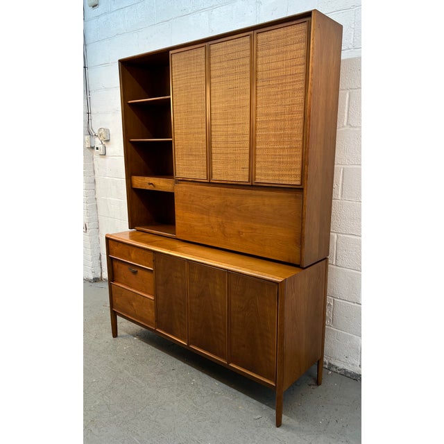 A stunning and highly collectible Mid-Century Modern credenza and hutch from Drexel's iconic Parallel collection, designed...