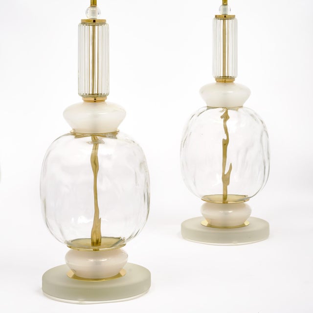 Pair of hand-blown Murano glass lamps featuring unique glass components on a brass structure. In the style of iconic...