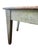 This piece has a distinct, mottled green painted base with tapered legs. The top features large, wide planks of wood with...