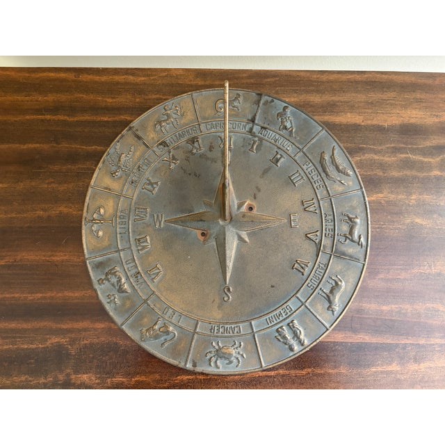 A classic round iron garden sundial featuring the 12 zodiac signs, inspired by traditional English estate landscapes....